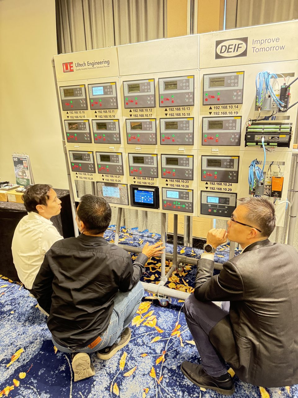 Wall of DEIF genset controllers configured by ULTECH engineers during a training session
