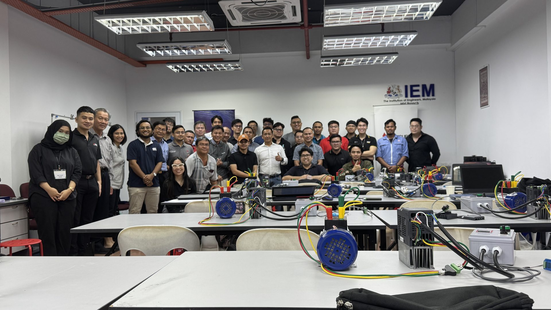 Full classroom of participants at an ULTECH technical training session with inverters on the desks